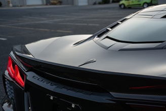 A black sports car parked in a parking lot