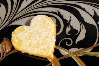 A heart shaped piece of bread on a fork