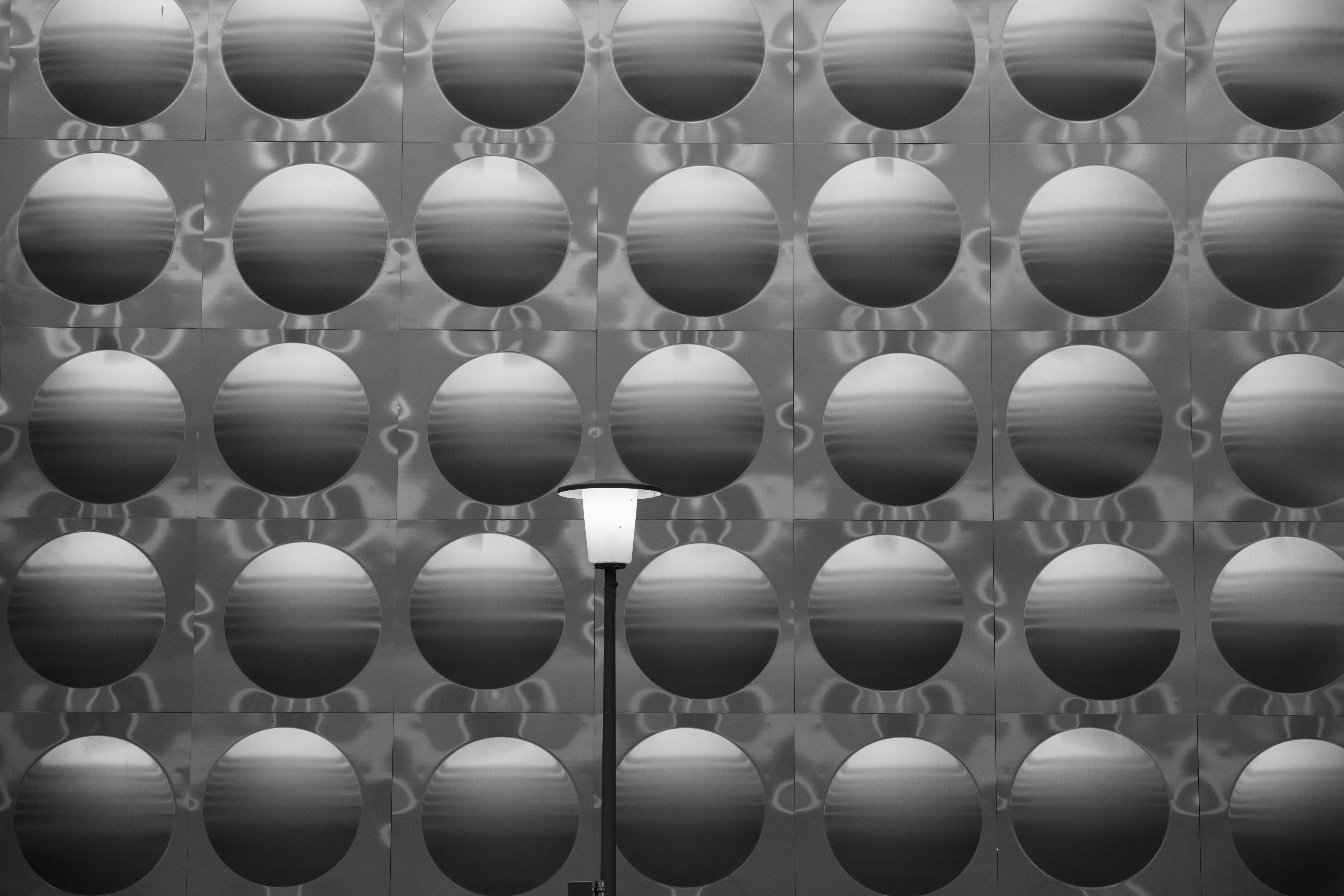 A black and white photo of a street light