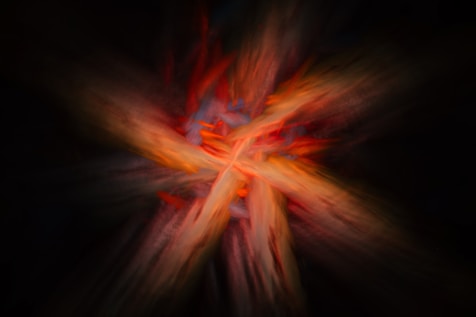 A blurry image of a cross on a black background