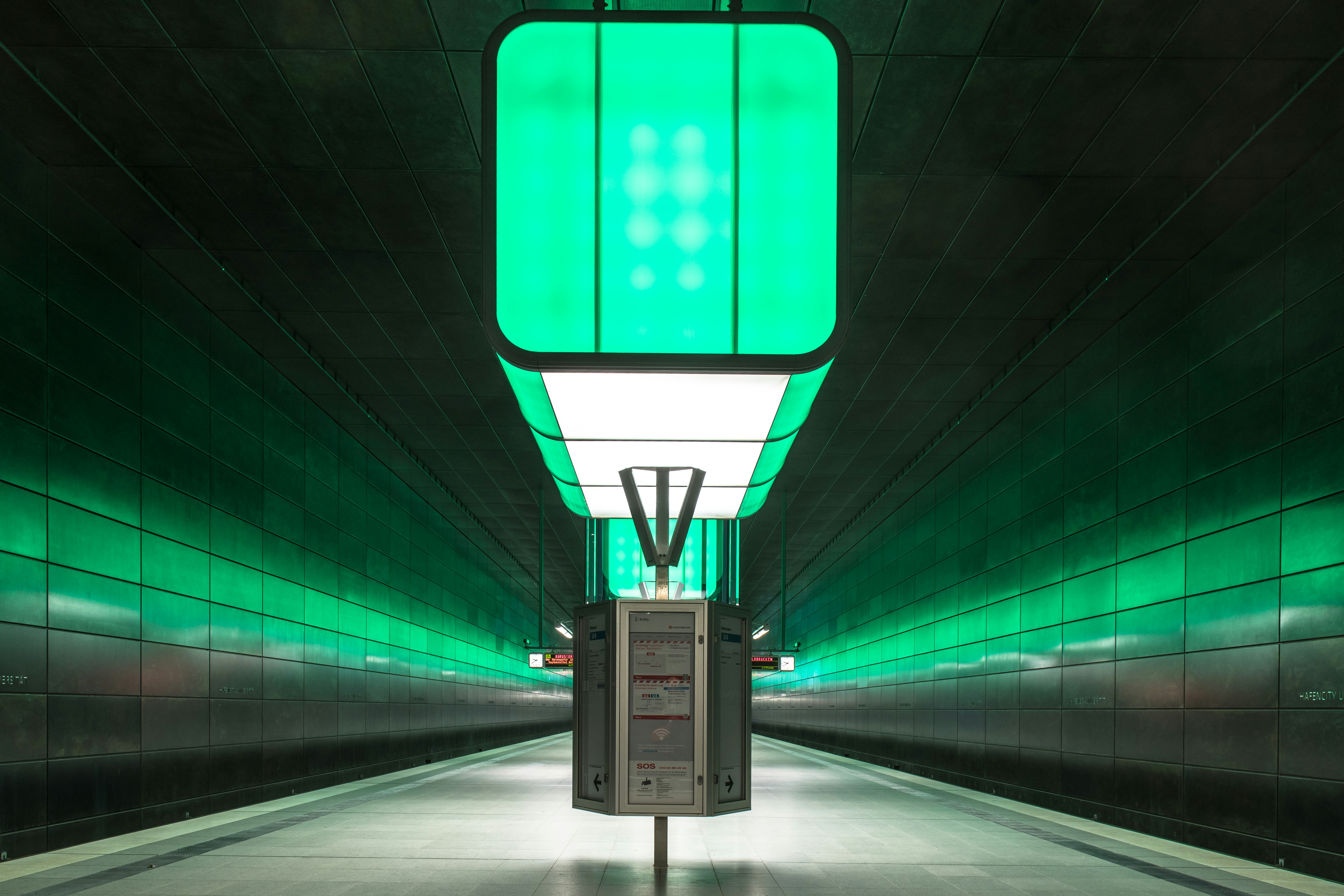 A green and white light in a dark tunnel