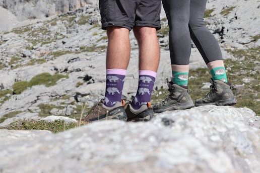 A couple of people standing on top of a mountain