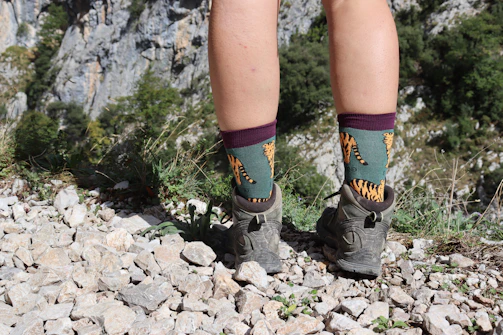 Person wearing socks on a rocky mountain trail — sustainable indigenous socks for everyday adventure
