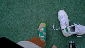 A group of people standing on top of a green field