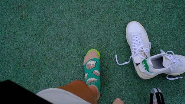 A group of people standing on top of a green field