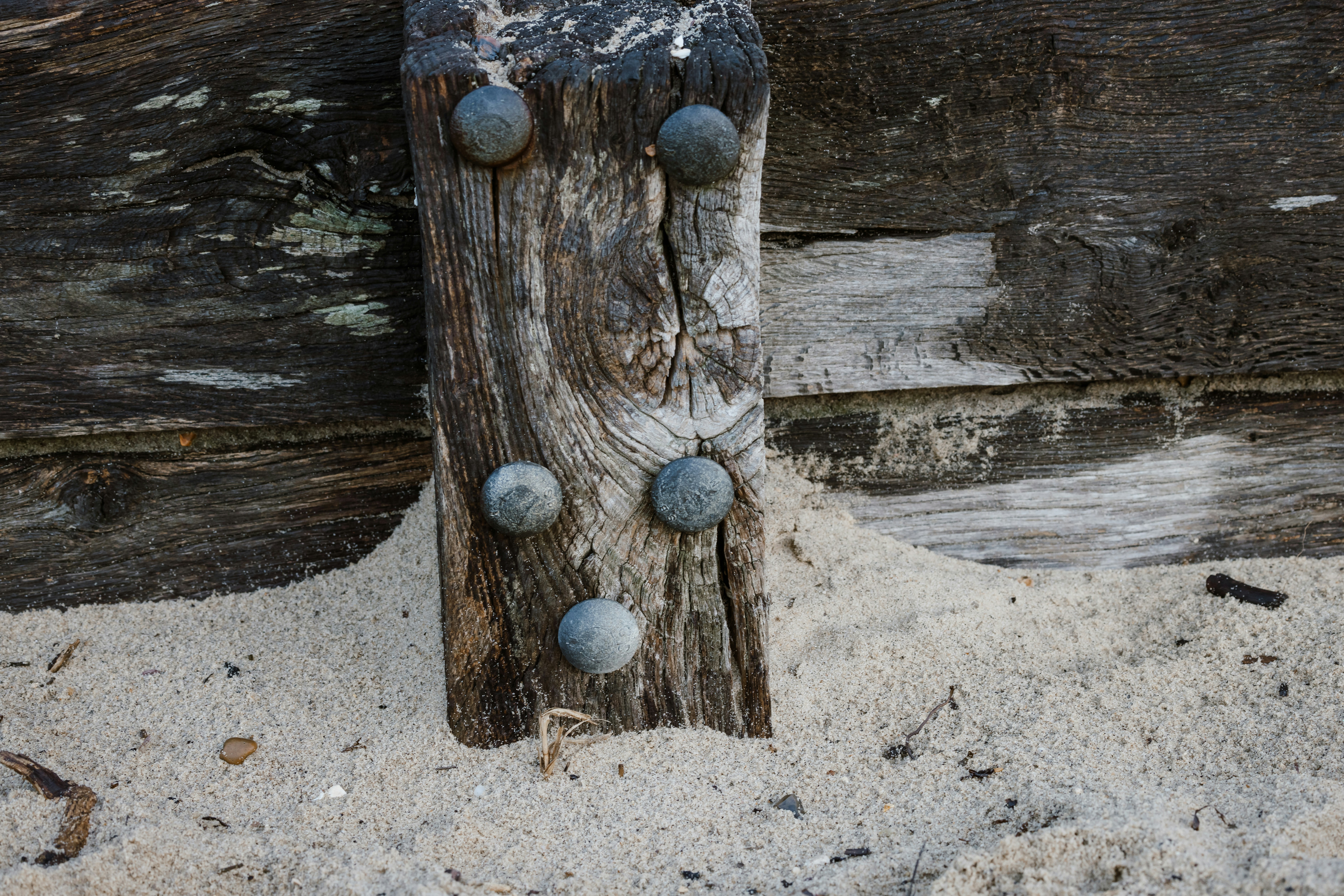 A piece of wood that has some balls on it