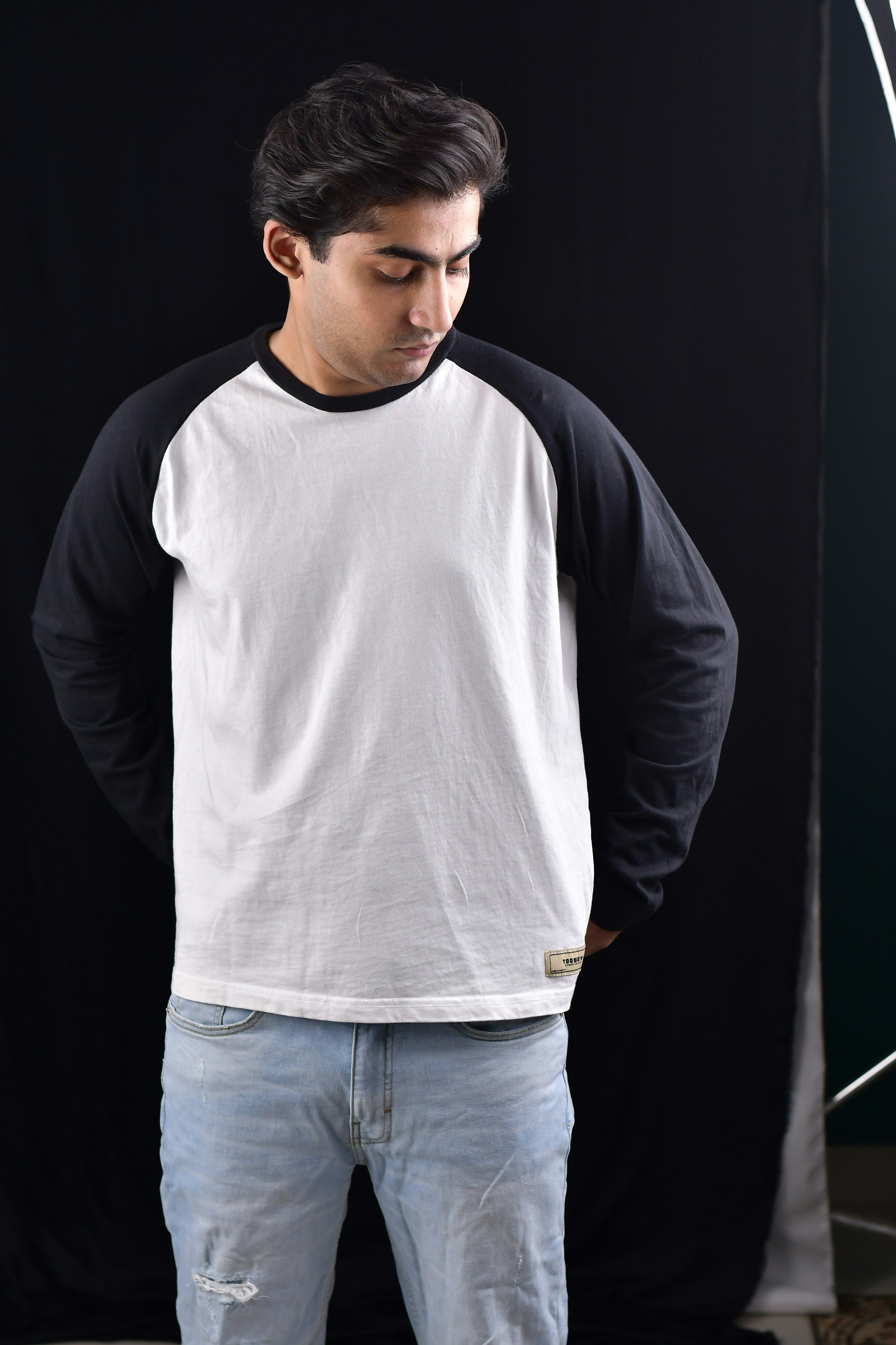 A man standing in front of a black and white backdrop