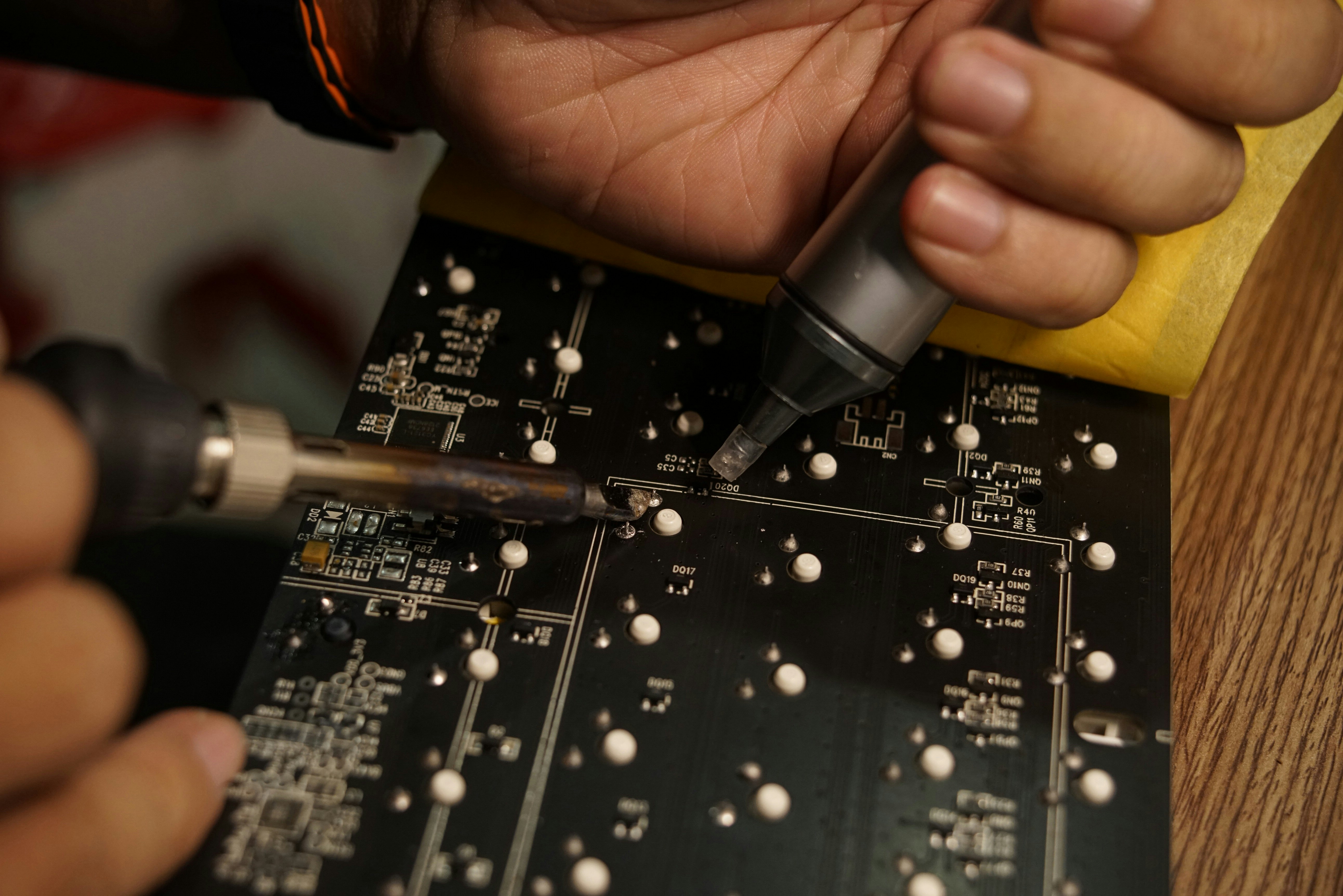 technician repairing circuit board - automotive electronic repair