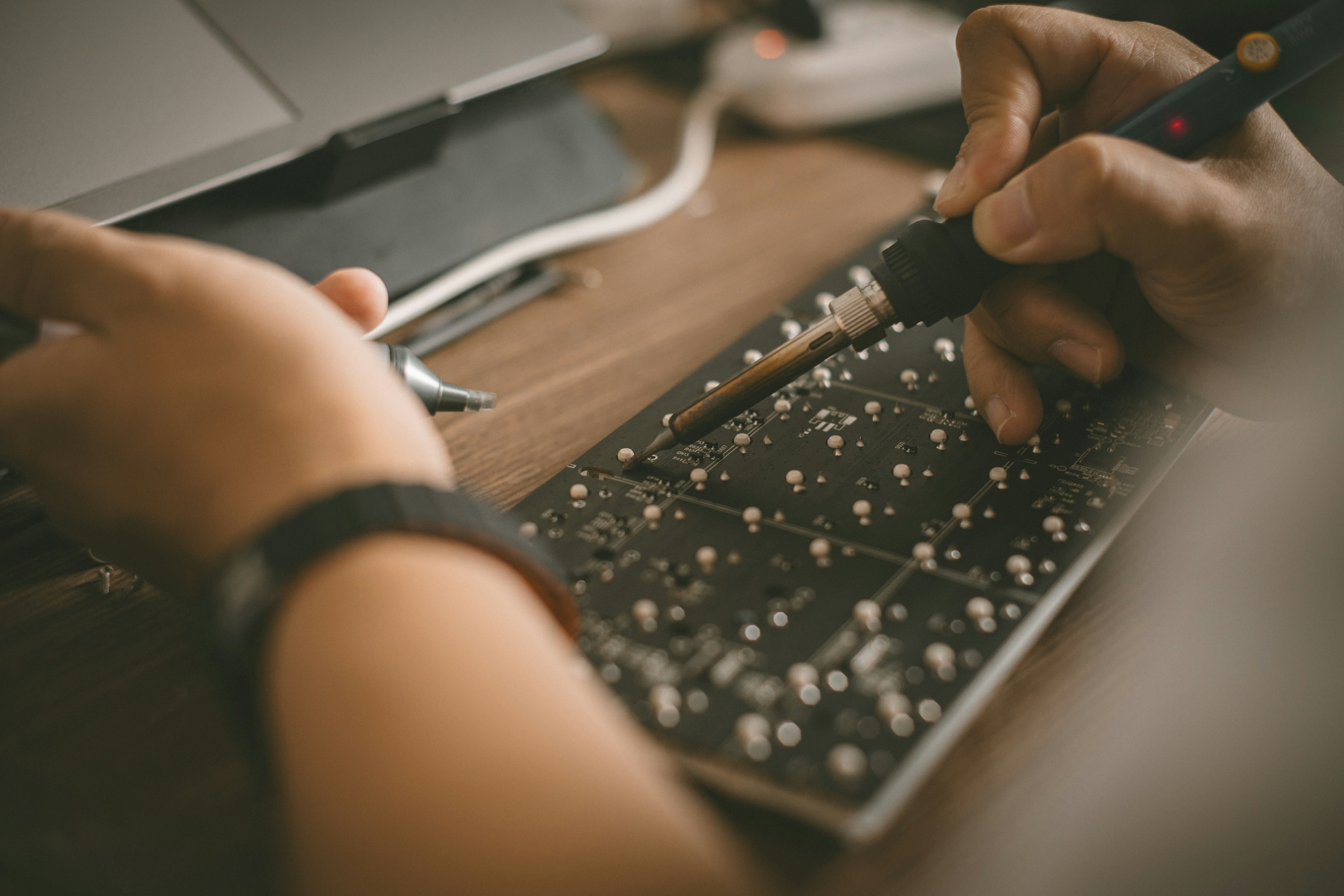 A person is typing on a laptop keyboard
