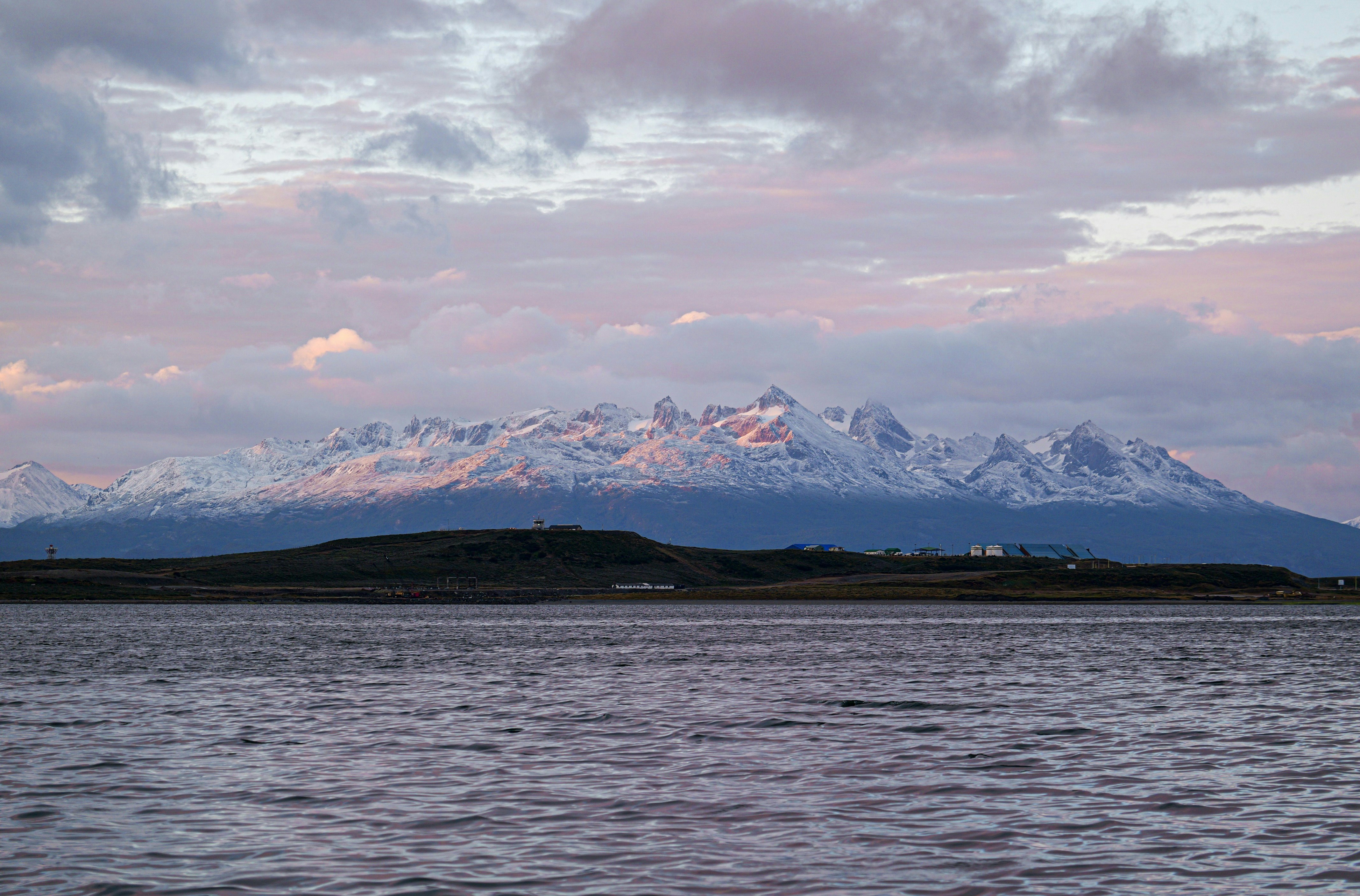 A large body of water with a mountain in the background
