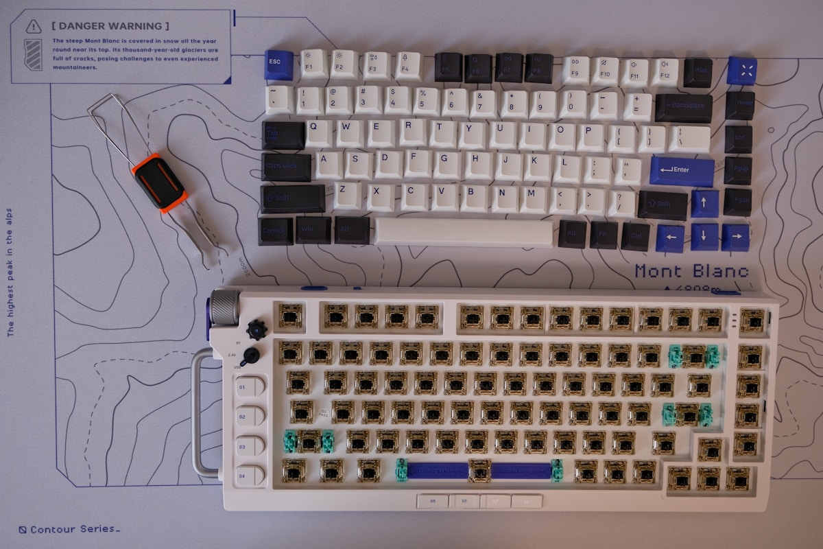 A computer keyboard and a computer mouse on a table
