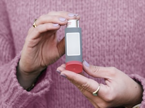 A woman holding a small electronic device in her hands