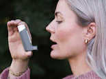 A woman holding a cell phone up to her face