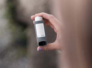 A person holding a bottle in their hand