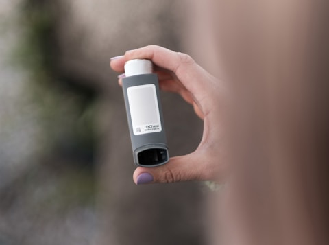 A person holding a bottle in their hand