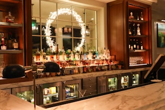 A bar with lots of bottles of alcohol