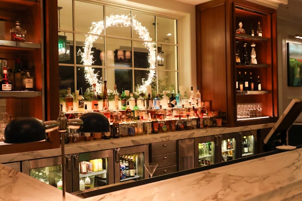 A bar with lots of bottles of alcohol