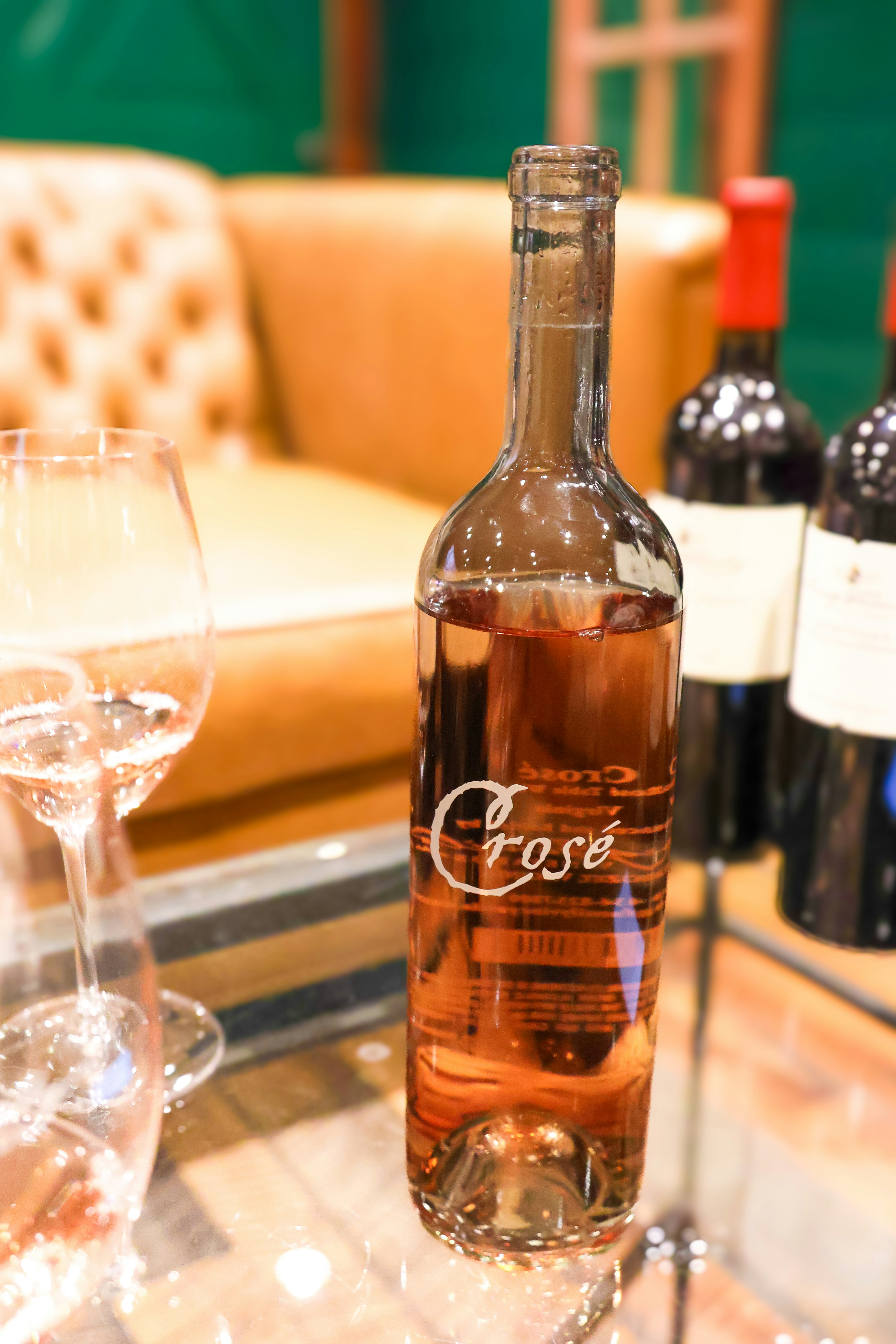 A bottle of wine sitting on top of a glass table