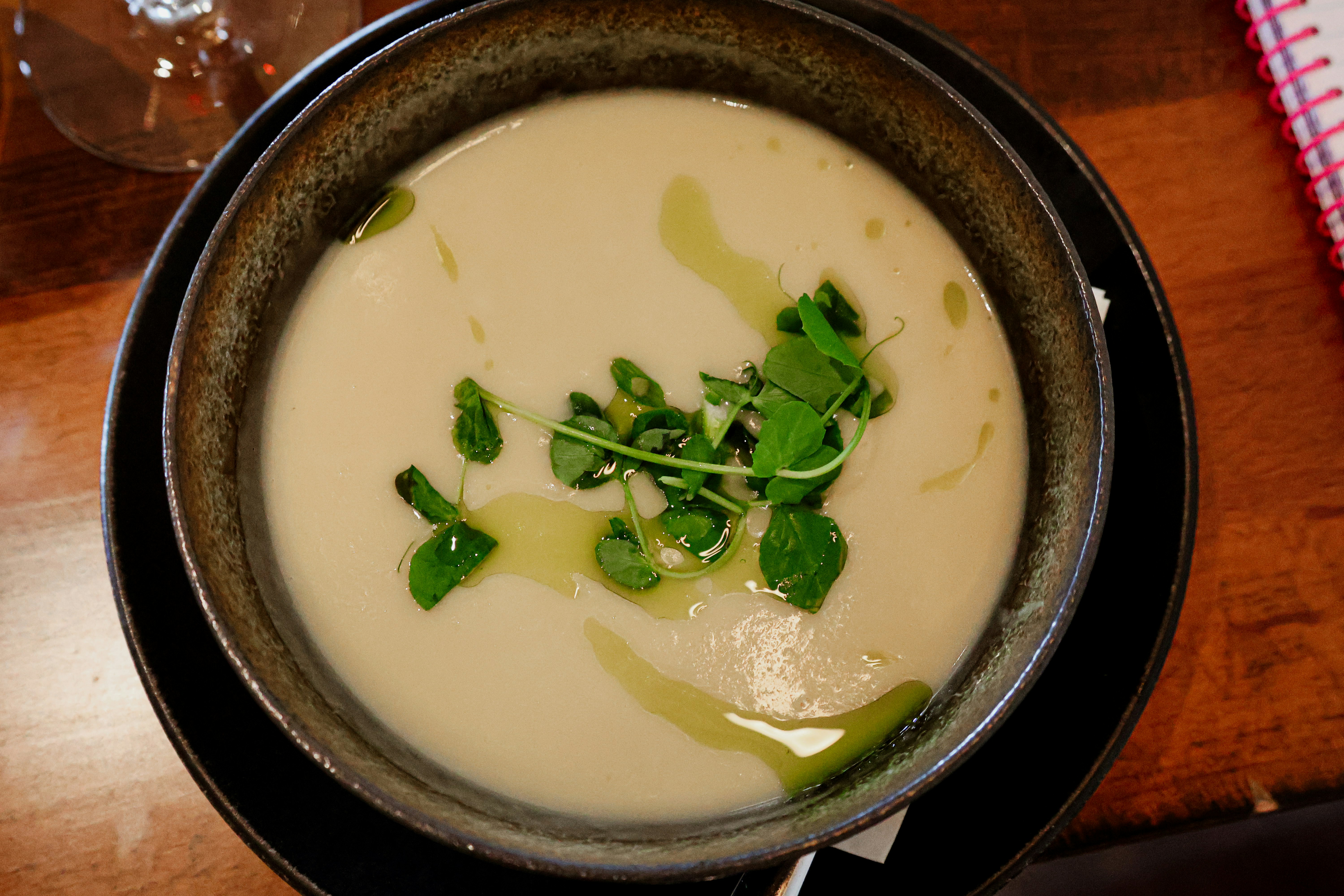 A bowl of soup on a wooden table