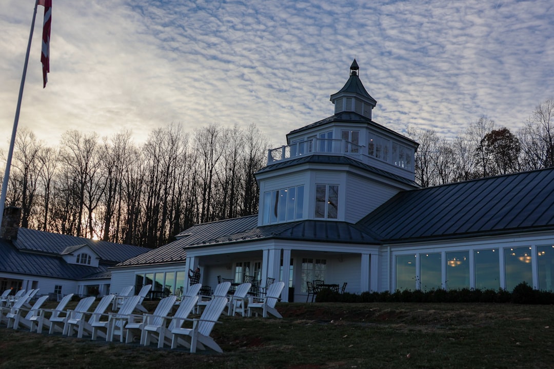 A large white building with a flag on top of it, Trump winery and tasting room