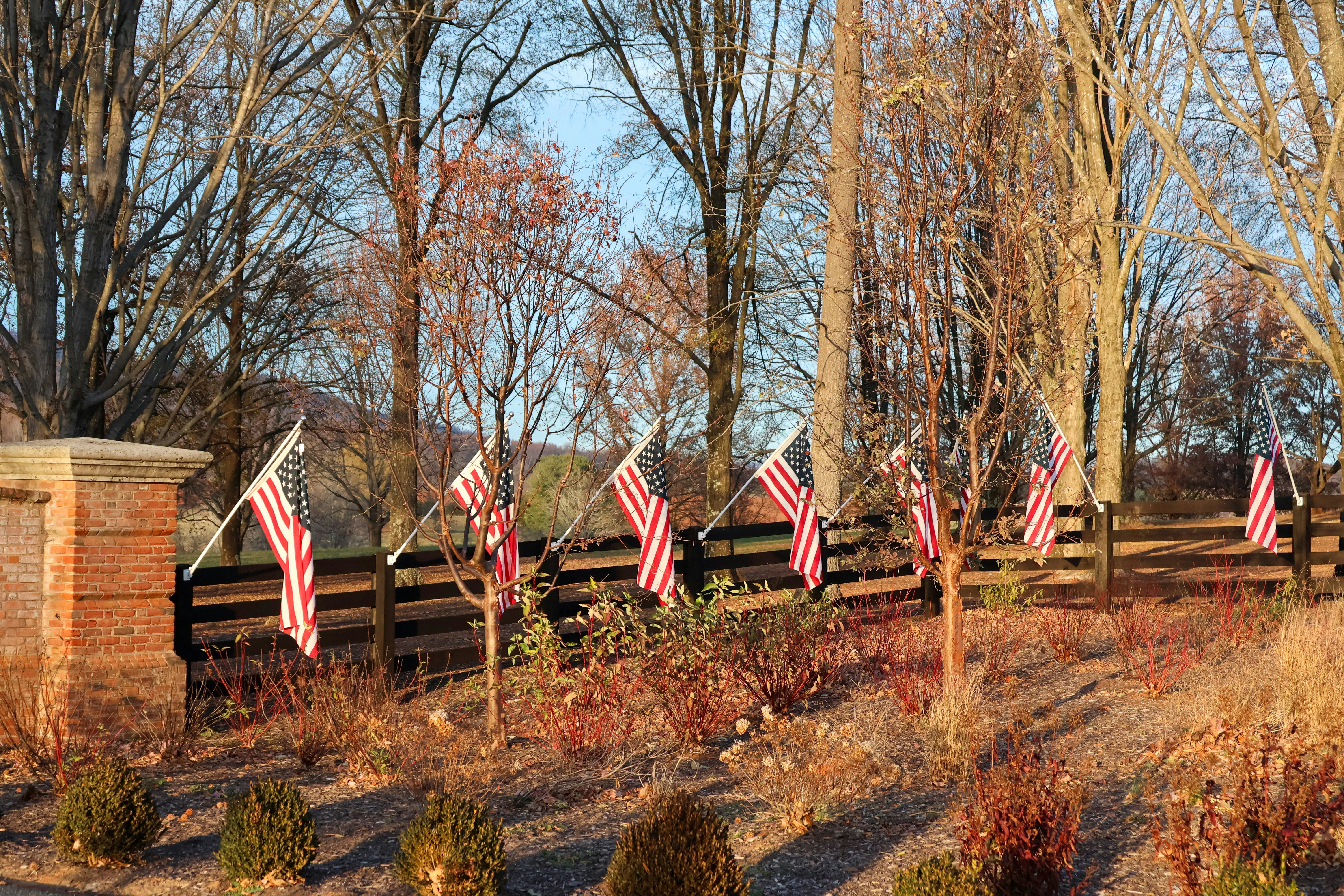 A wooden fence with american flags on it