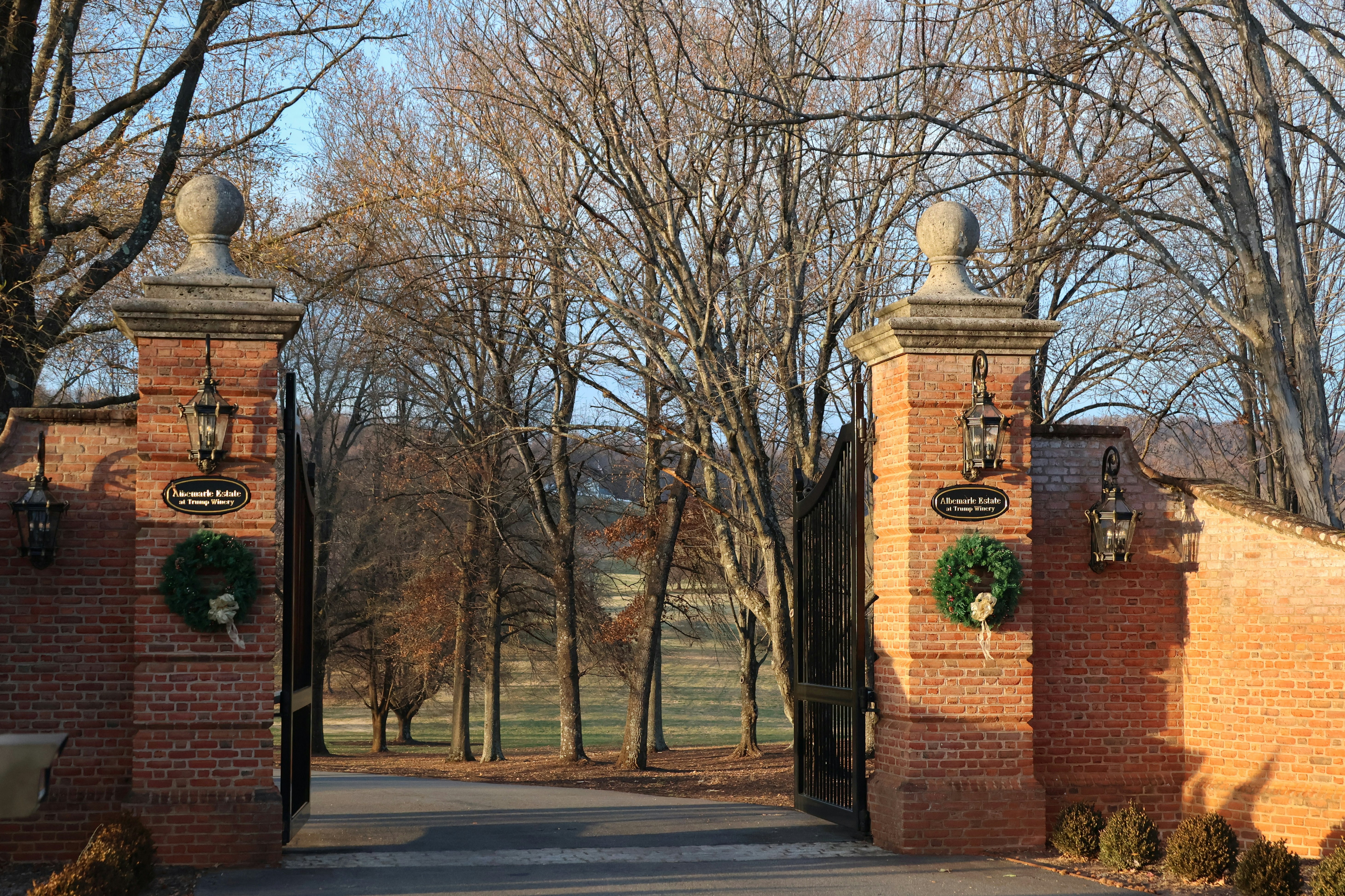 A brick gate with wreaths on top of it