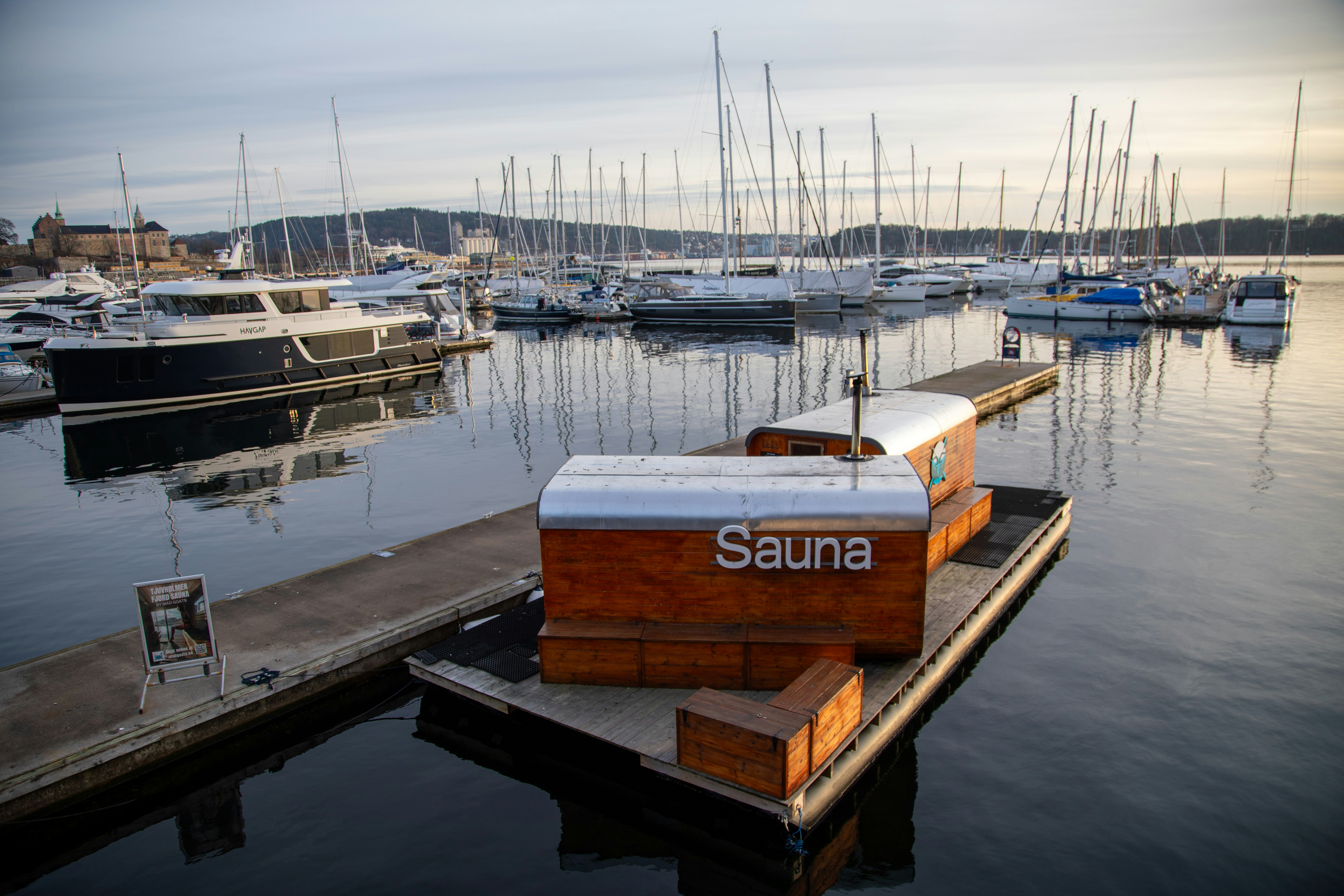 A boat dock with a bunch of boats in the water
