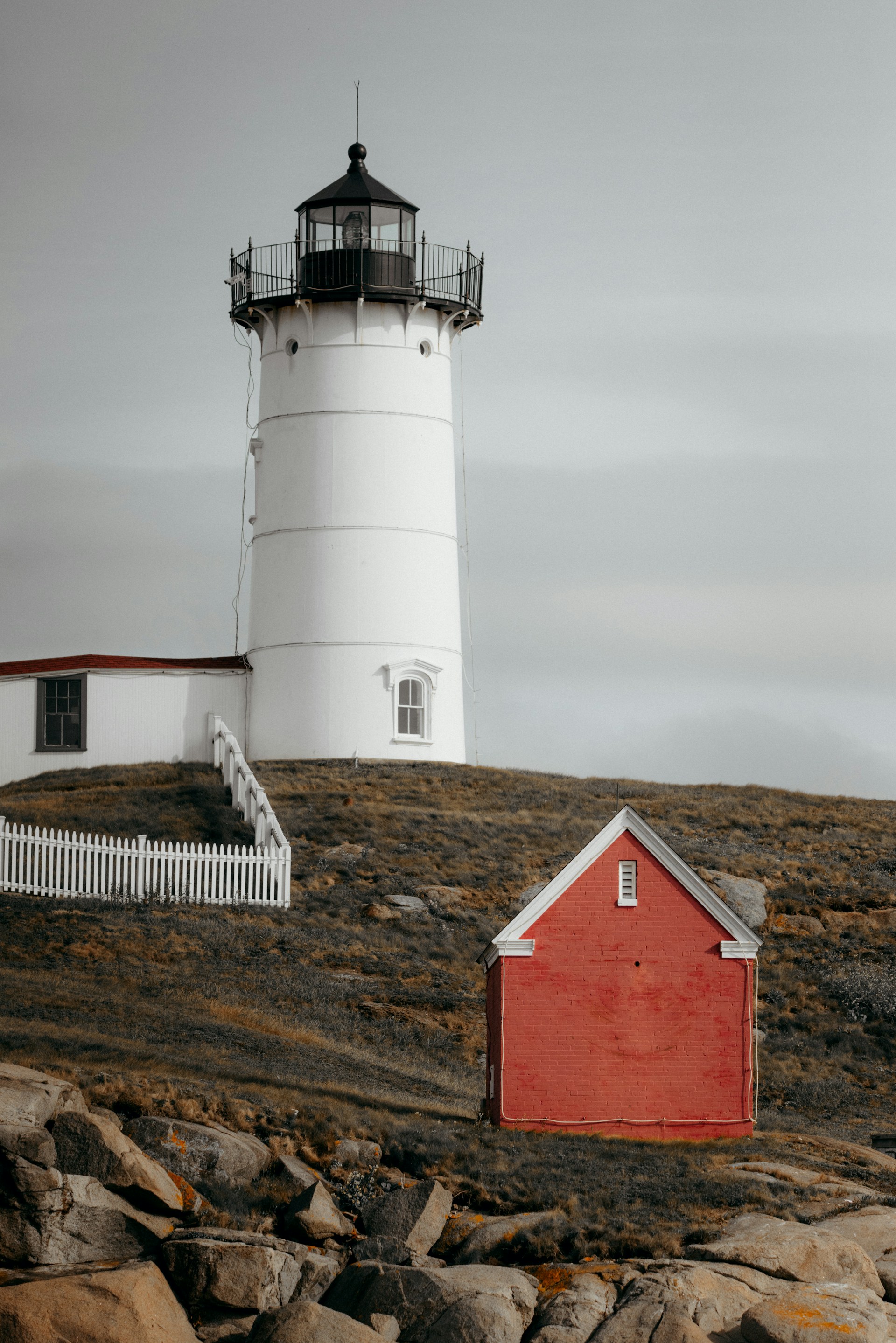 A lighthouse on top of a rocky hill