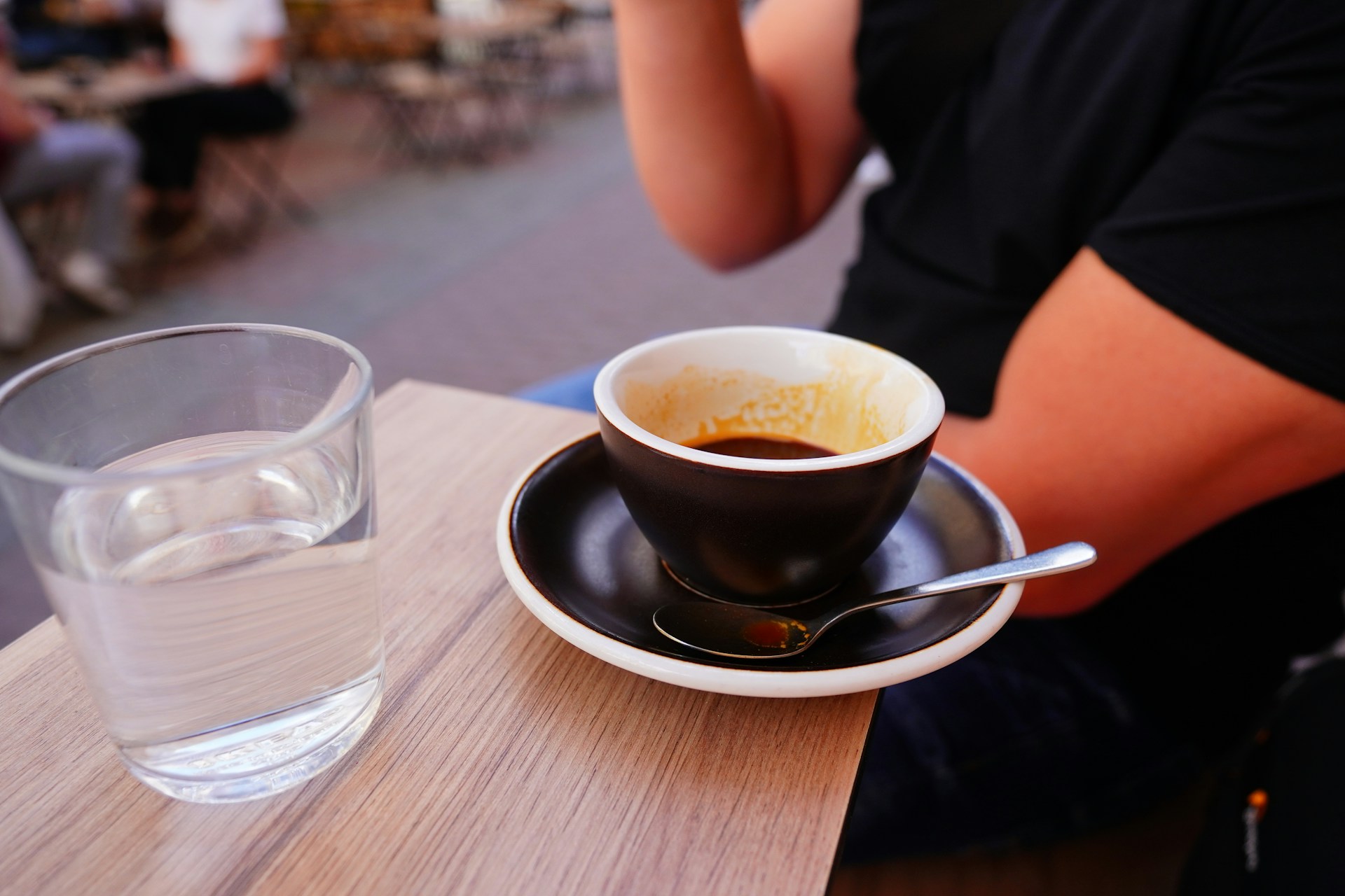 A person sitting at a table with a cup of coffee