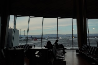 A couple of people sitting at a table in front of a window