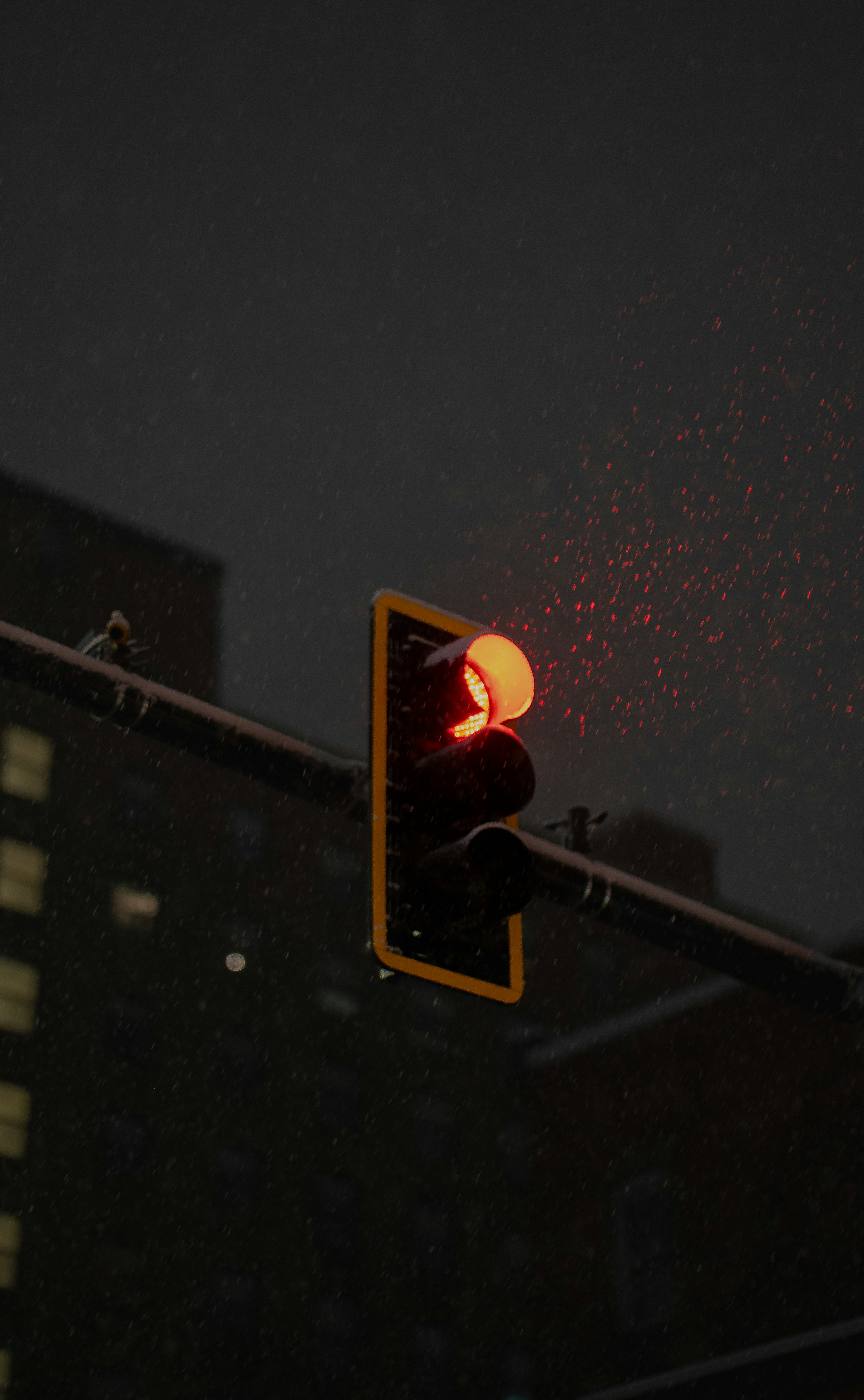 A traffic light on a pole with a building in the background
