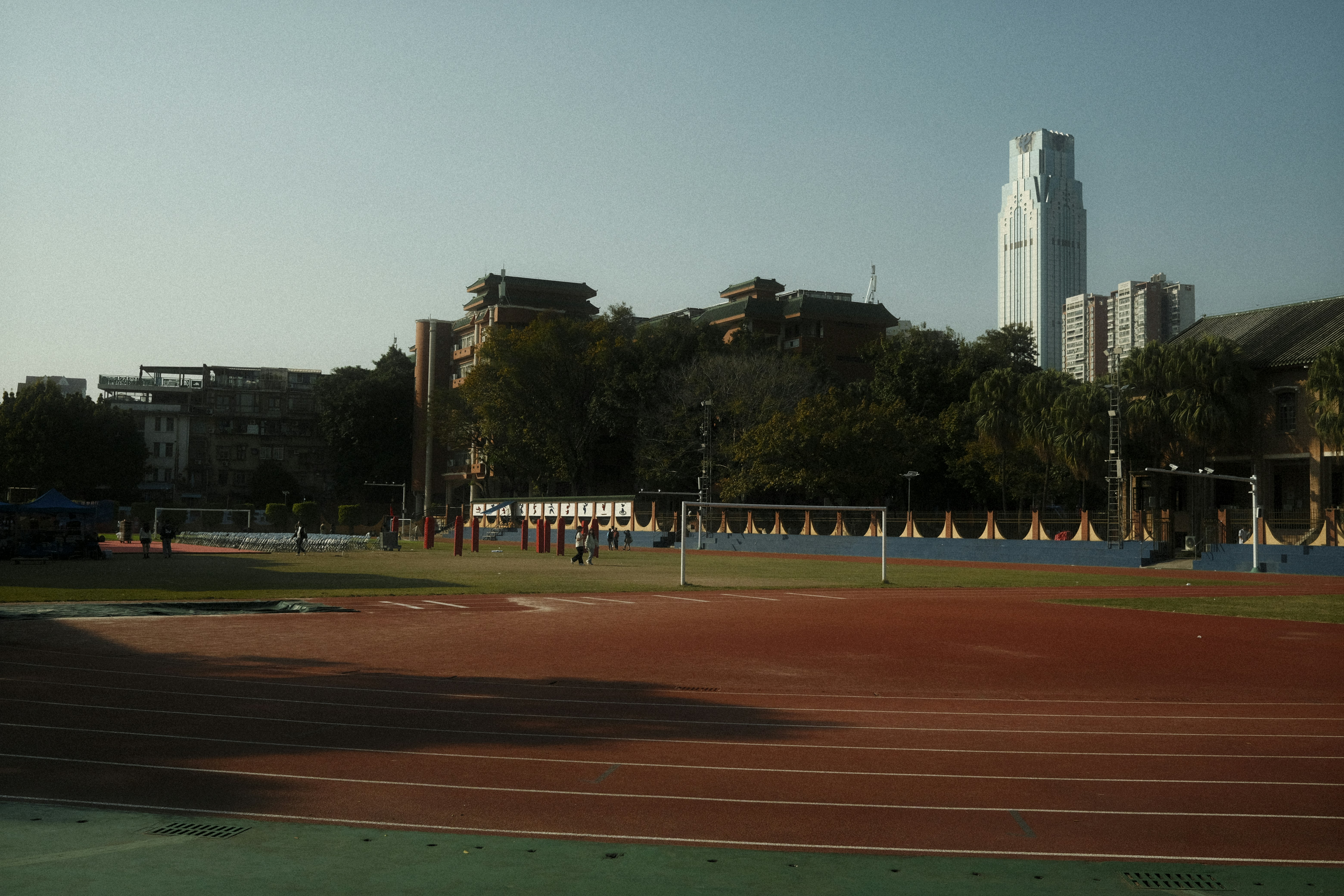 A view of a stadium with a tall building in the background