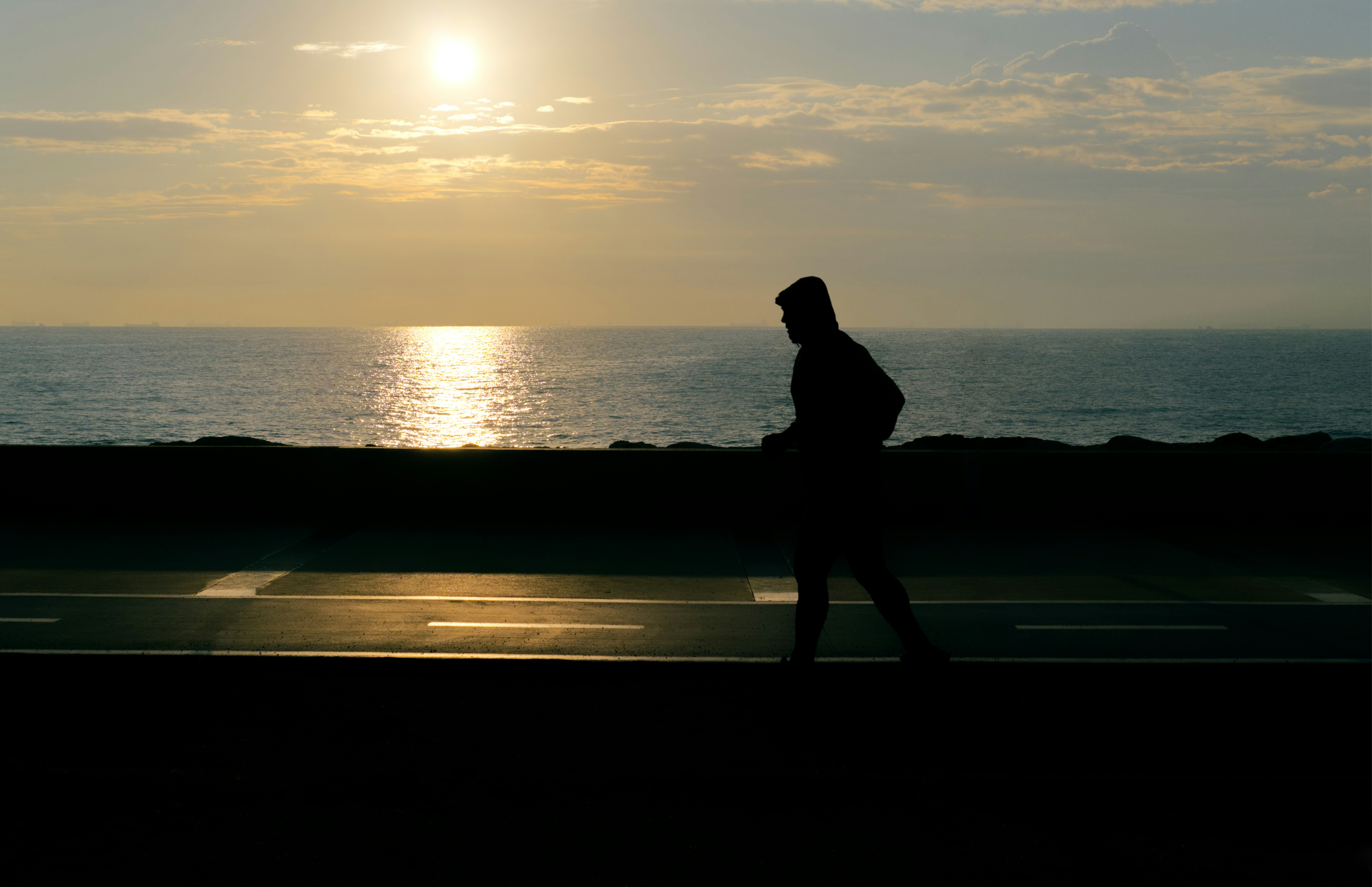 Silhouette walking on beach