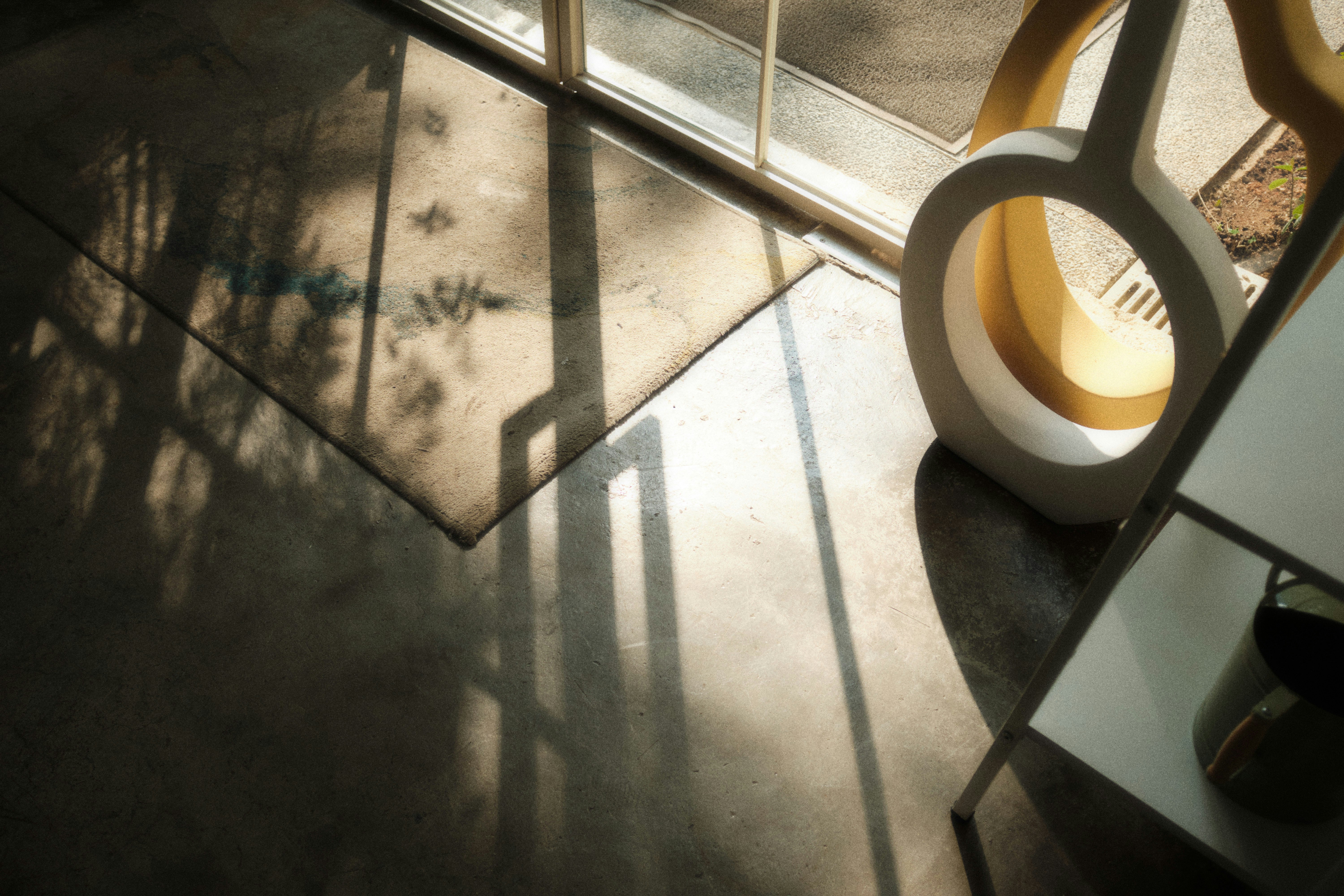 A room with a glass door and a mirror on the floor