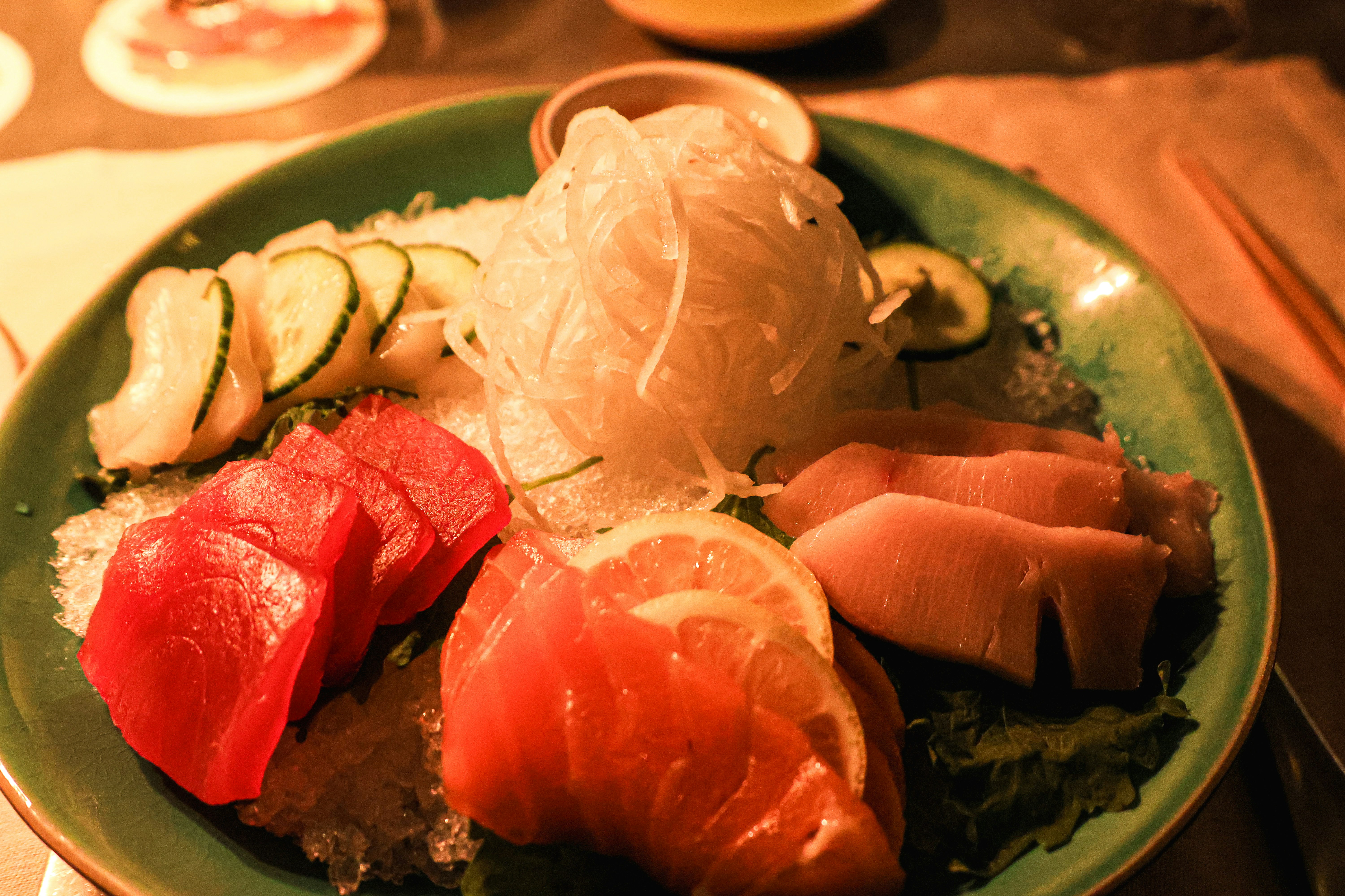 A green plate topped with lots of different types of food