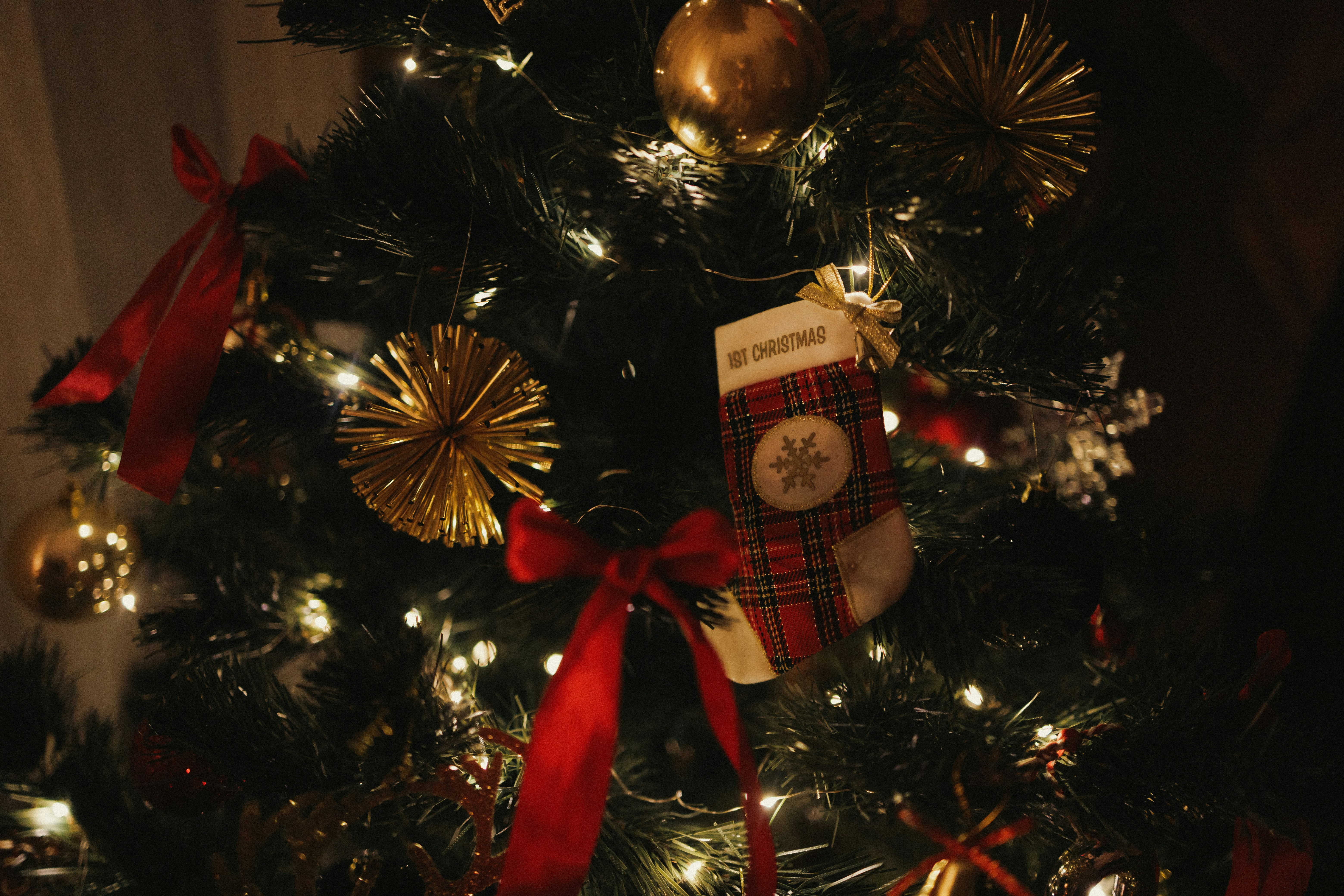 A decorated christmas tree with a teddy bear on it