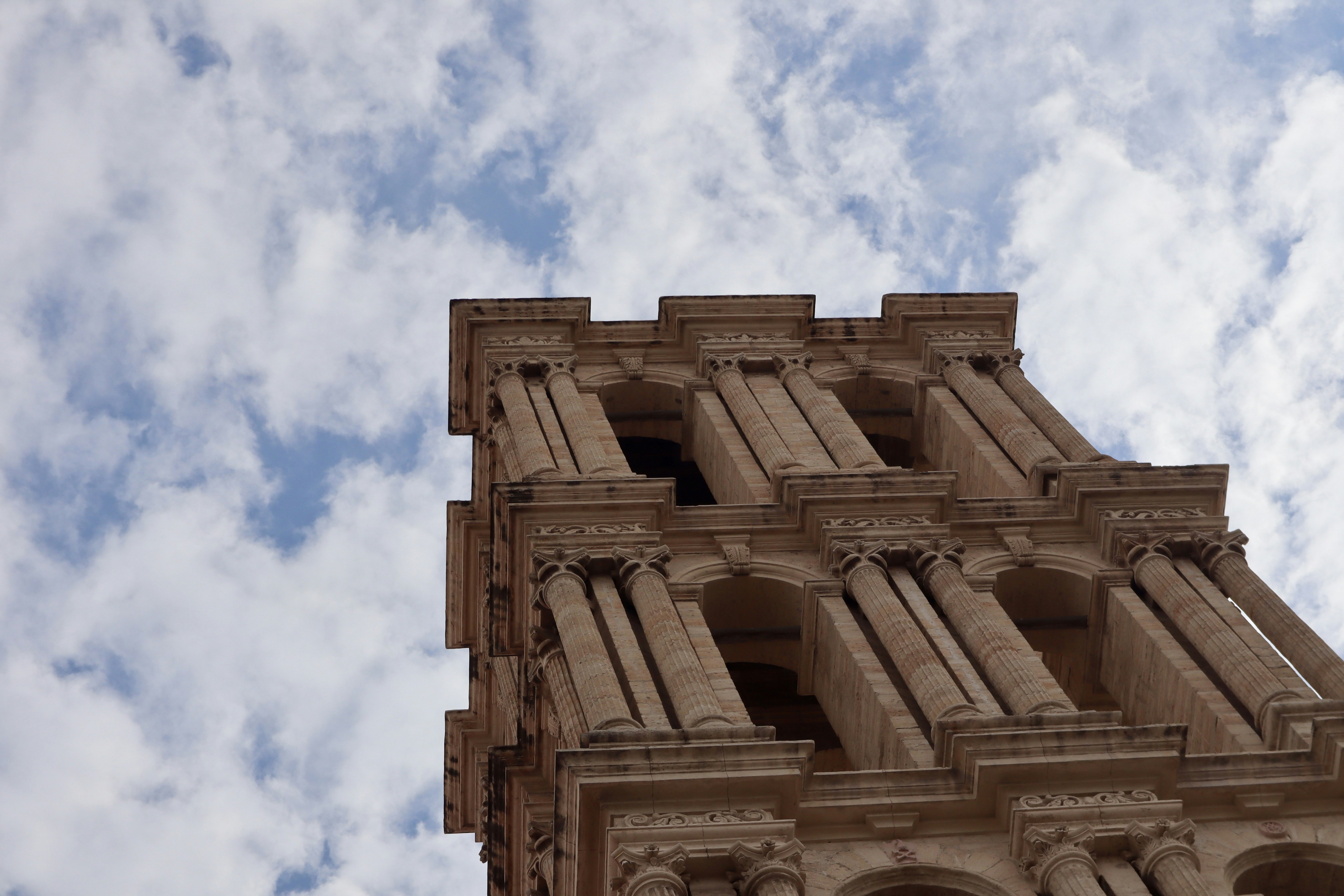 A very tall building with a clock on it's side