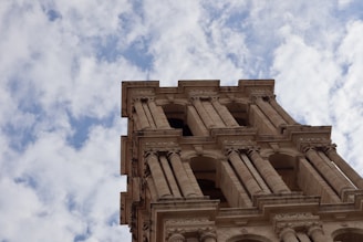 A very tall building with a clock on it's side