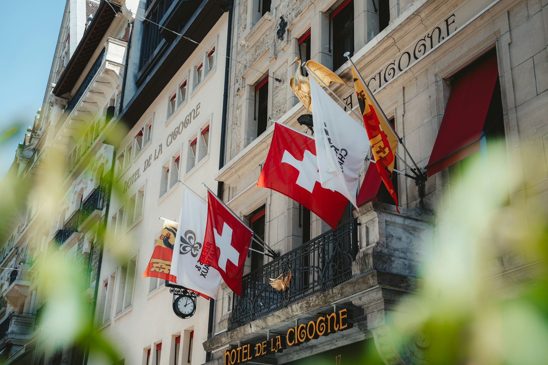 A group of canadian flags hanging from the side of a building