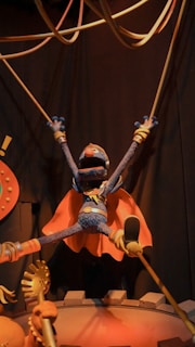 A figurine of a person on a stage with a microphone