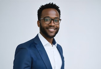 A man in a suit and glasses smiling