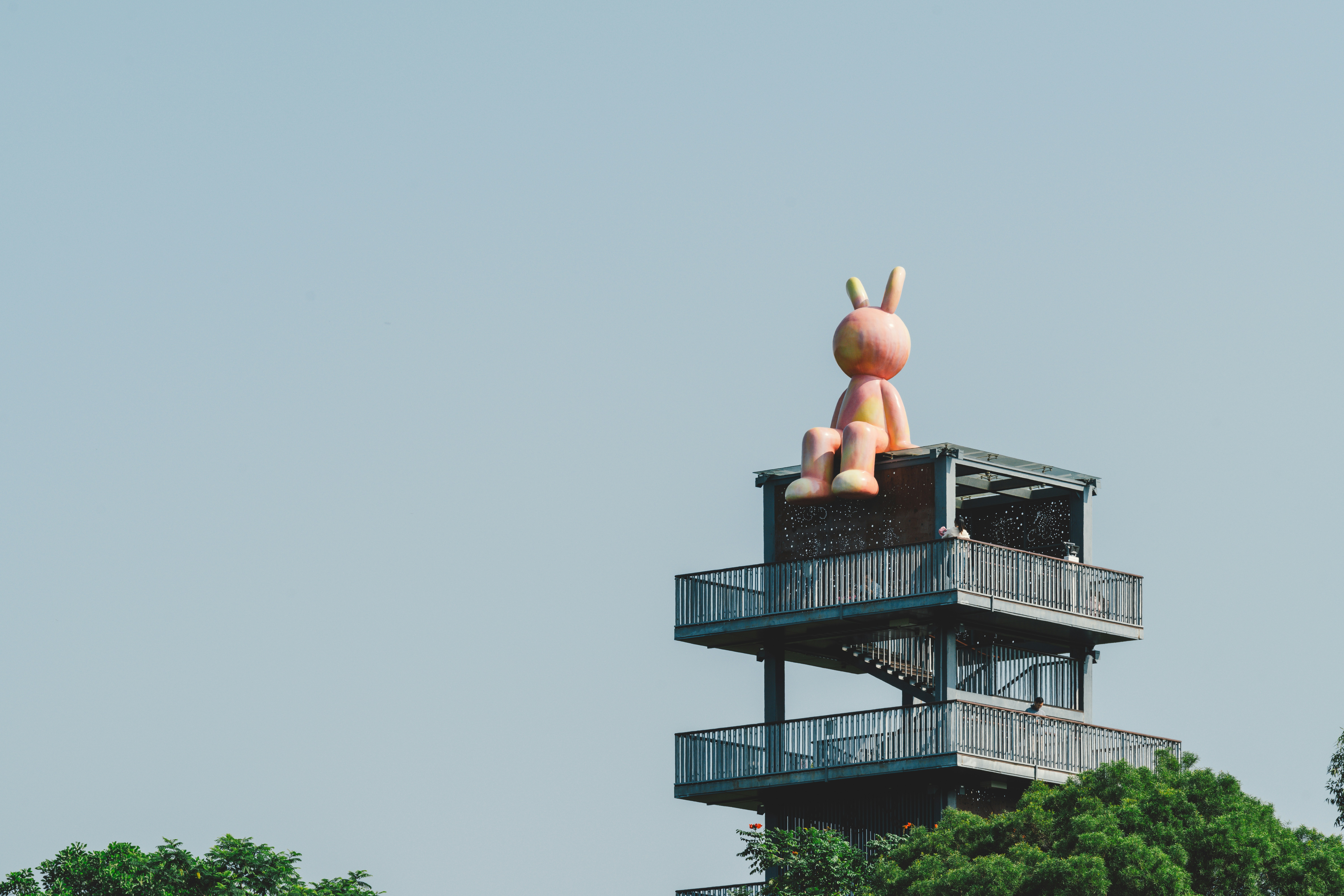 A statue of a person on top of a building