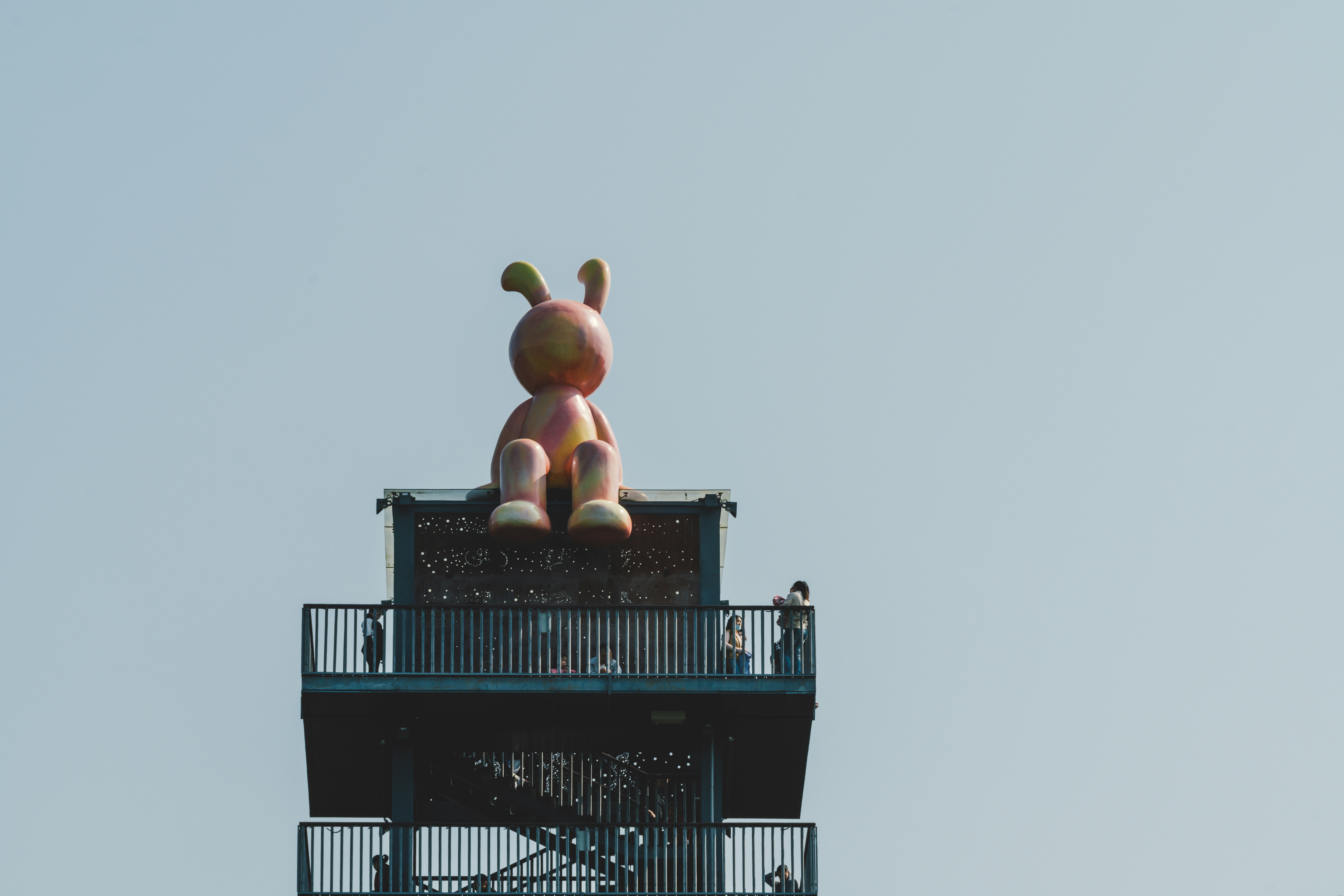 A large kite flying over a tall building