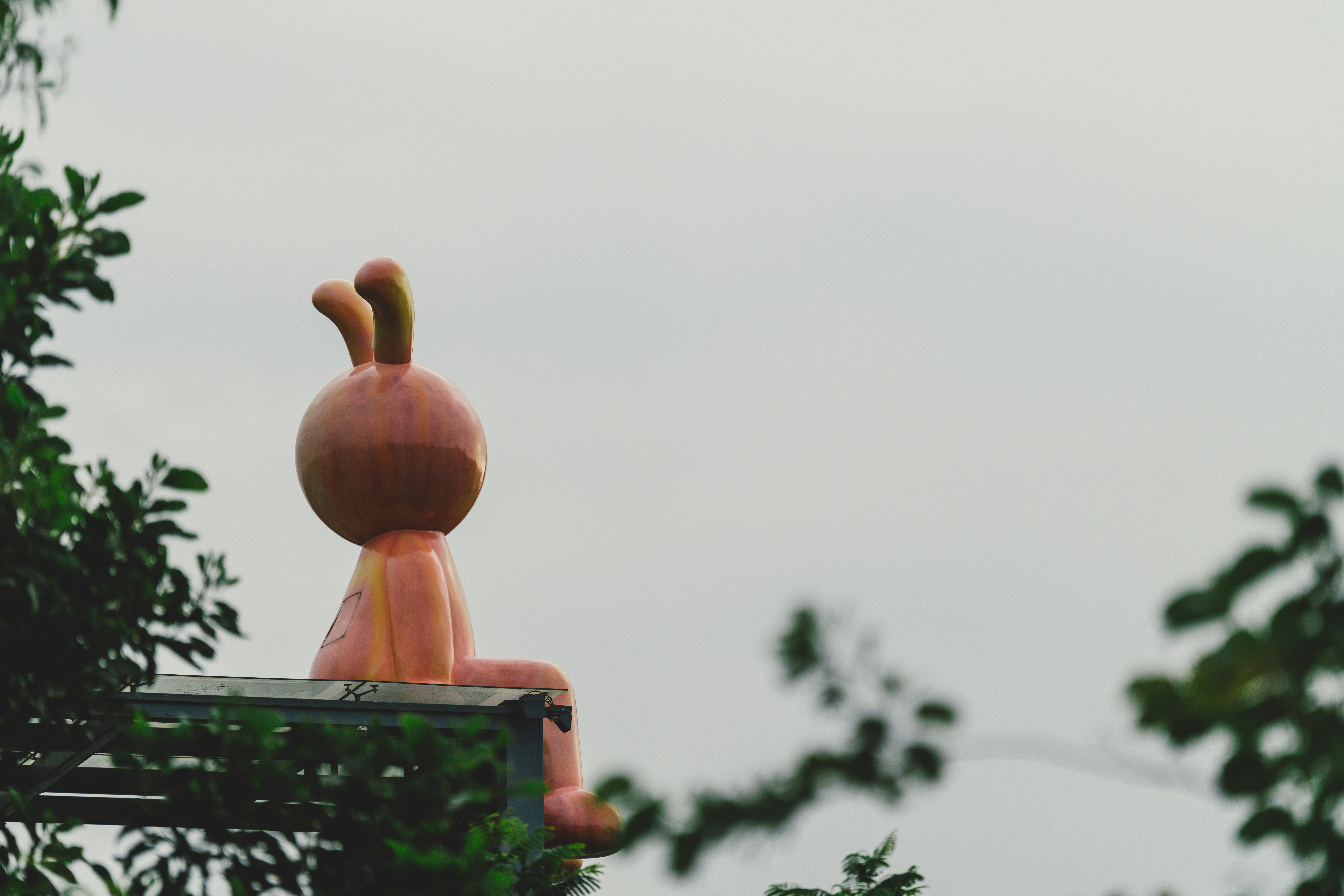 A statue of a person sitting on top of a bench