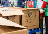 A group of people standing around boxes in a store