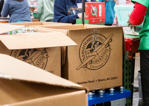 A group of people standing around boxes in a store