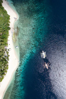 An aerial view of a boat in the ocean