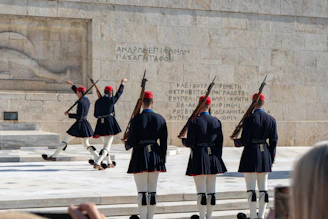 A group of men in uniform standing in front of a monument