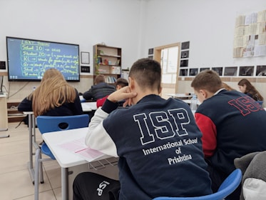 A group of students sitting at desks in a classroom