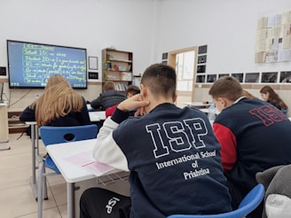 A group of students sitting at desks in a classroom